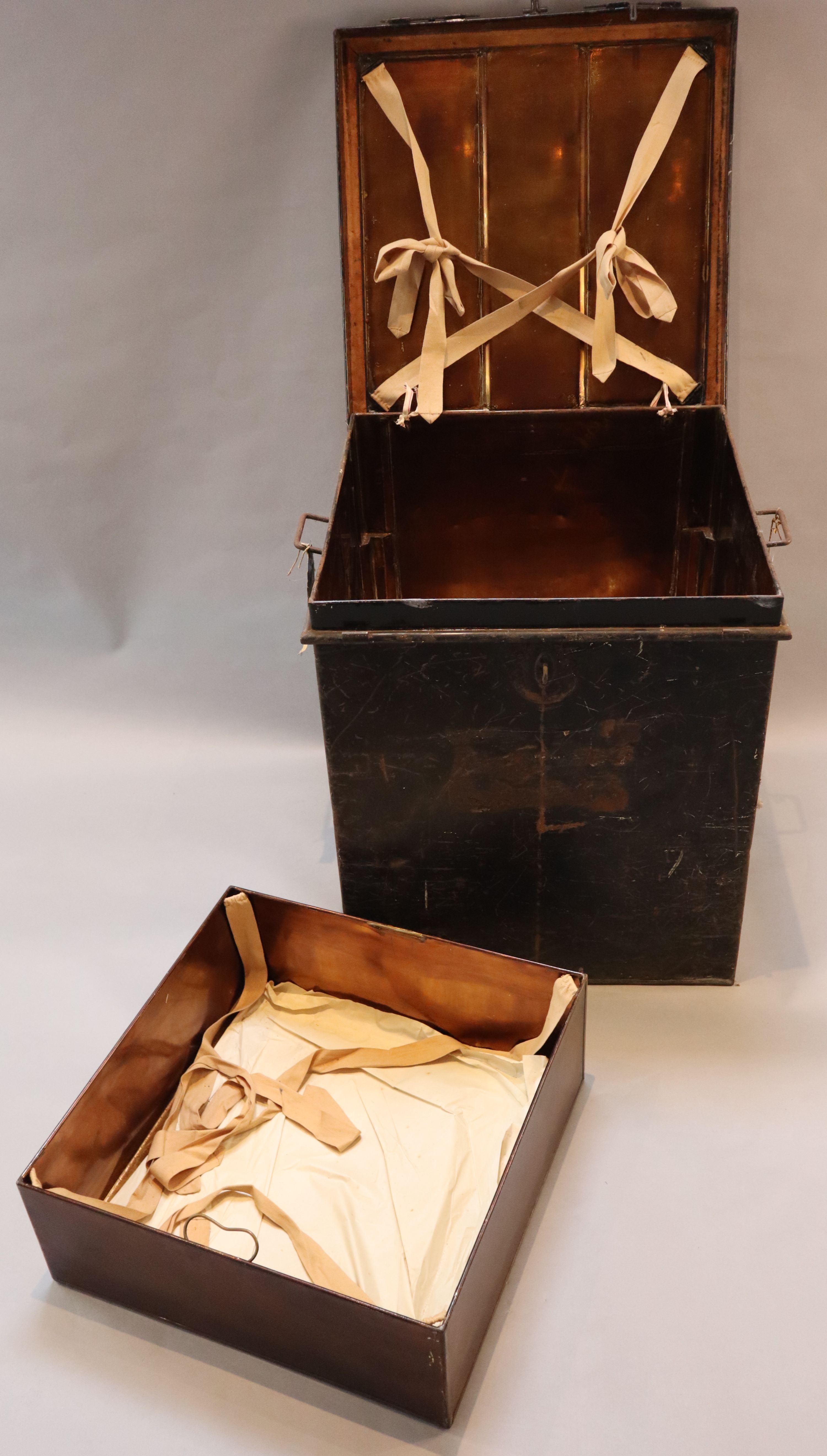An early 20th century black painted tin travelling trunk, inscribed Lady Brabourne with old British India and Cooks Travel labels, wi
